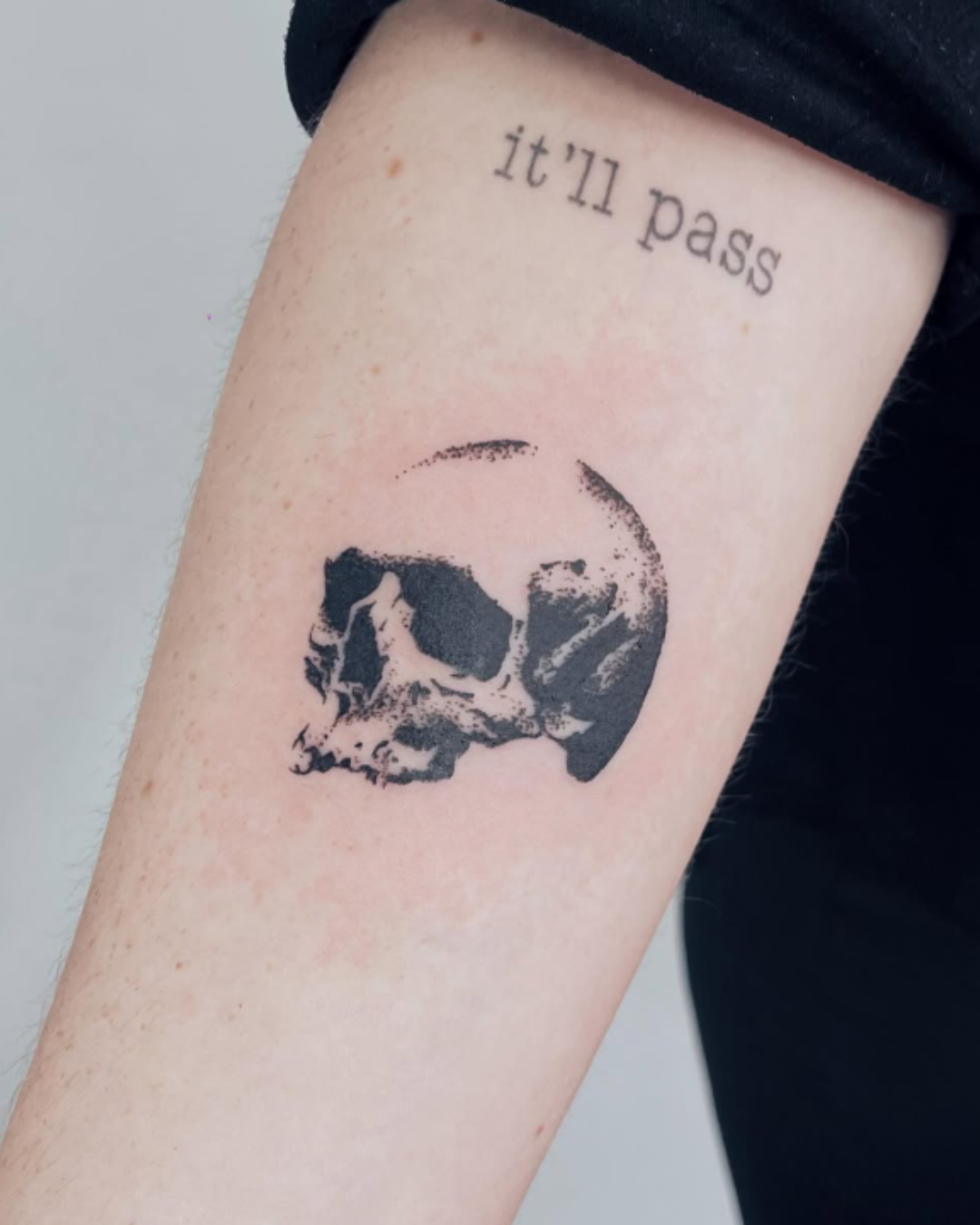 tattoo caveira minimalista braço preto e branco